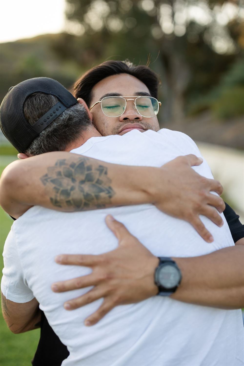 Two LEEF House participants sharing a long hug outdoors