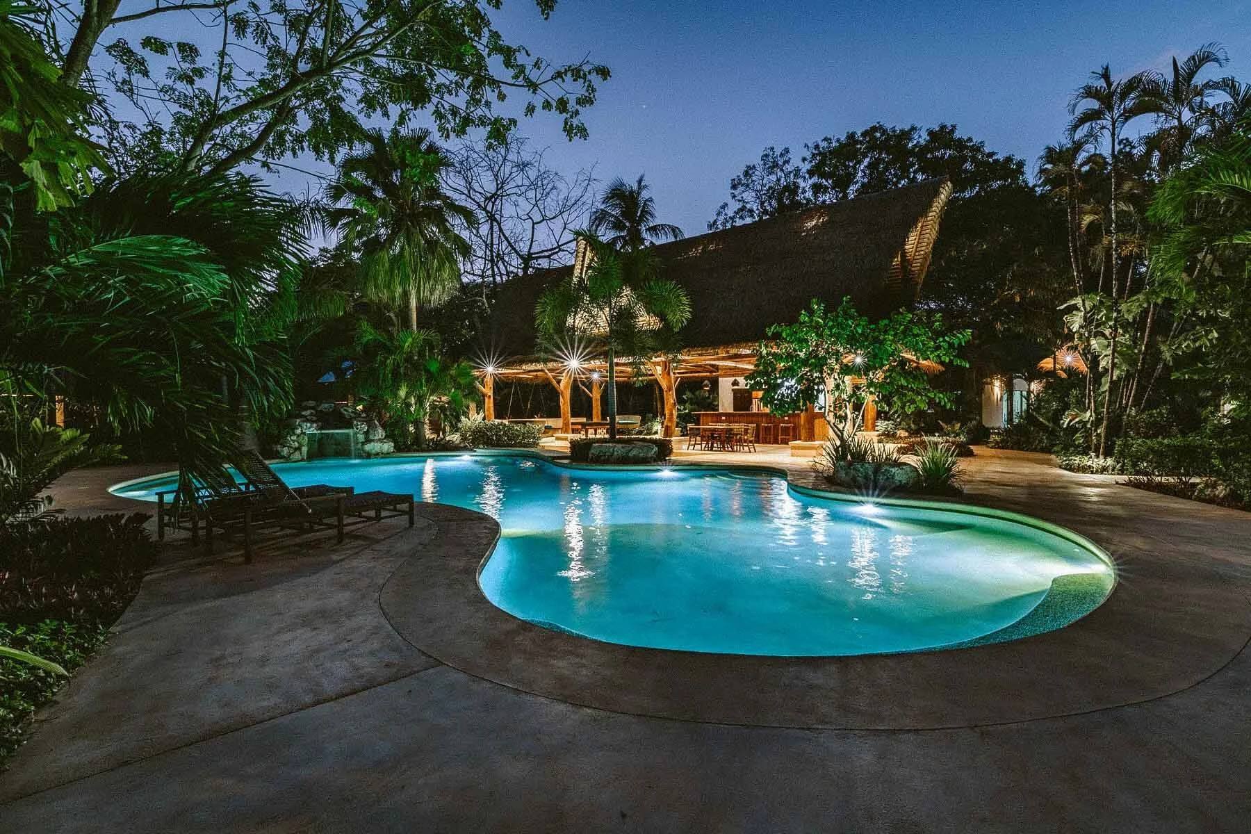 The pool and open-air rancho at Paradise Villas in Nosara, Costa Rica, at dusk
