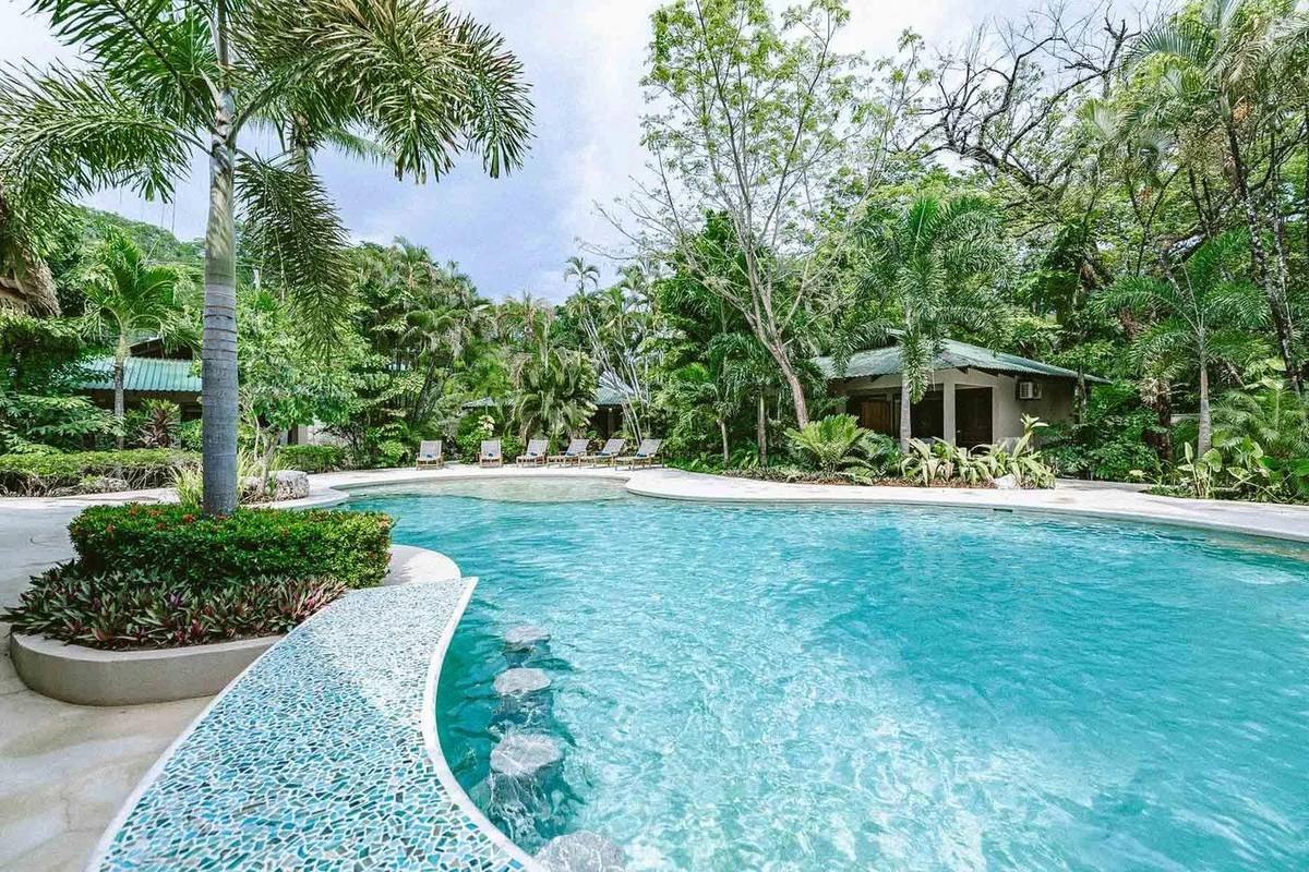 The pool among the tropical gardens at Paradise Villas